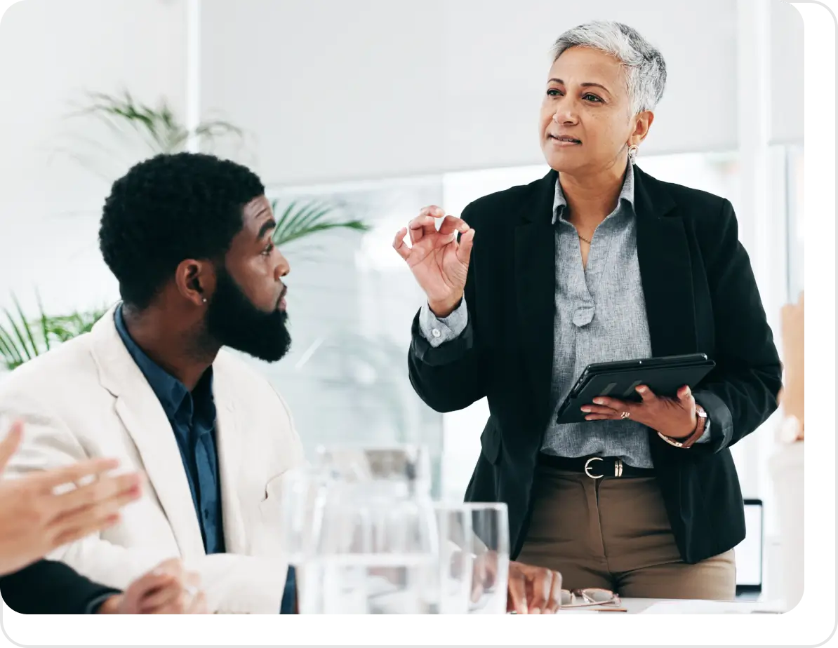 Woman in a suit talking to a man.
